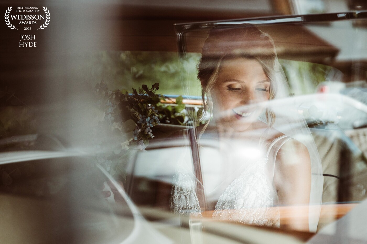 Sometimes the timing just hits just right! Reflections can be tricky to shoot through but with the correct lighting you can get some lovely candid shots. This one is the arrival of the Bride getting ready to meet her Husband to be!