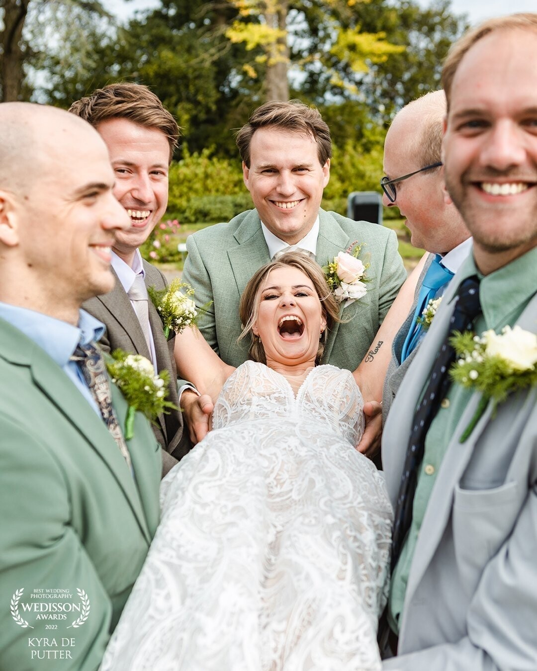 This photo is taken on the weddingday of E & A. The bride is such an enthusiastic young woman. She would do anything for the perfect groupfoto with her friendgroup. This photo is taken a little moment before she was thrown high in to the air. She had no fear at all! Fearless bride!