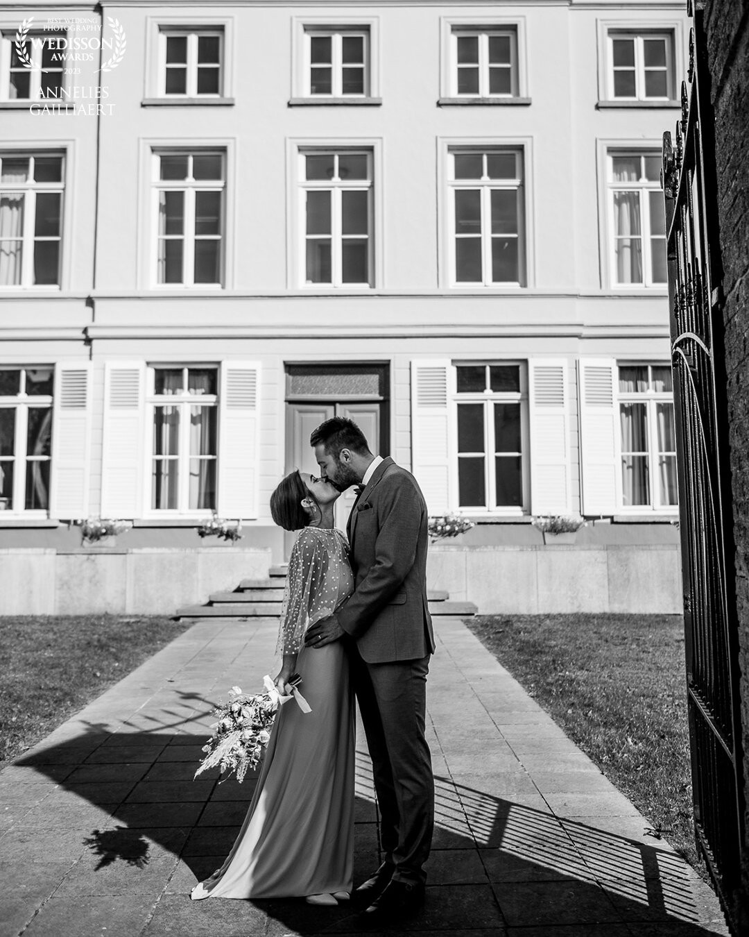 In front of the city hall where they got married. I loved the contrast of them in the shade, with the bright sun illuminating the building
