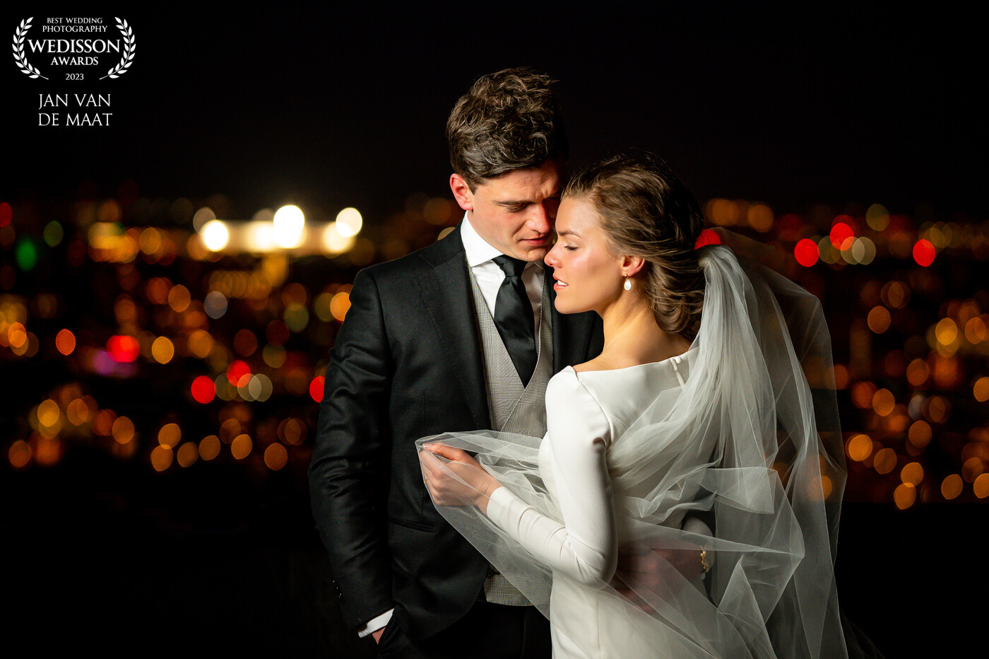 My first night scene on the rooftop! Standing around 100m high at the obsevation deck in cold windy conditions my couple had to be tough but I ended up with this image; a romantic scene with the city lights of Rotterdam on the background!