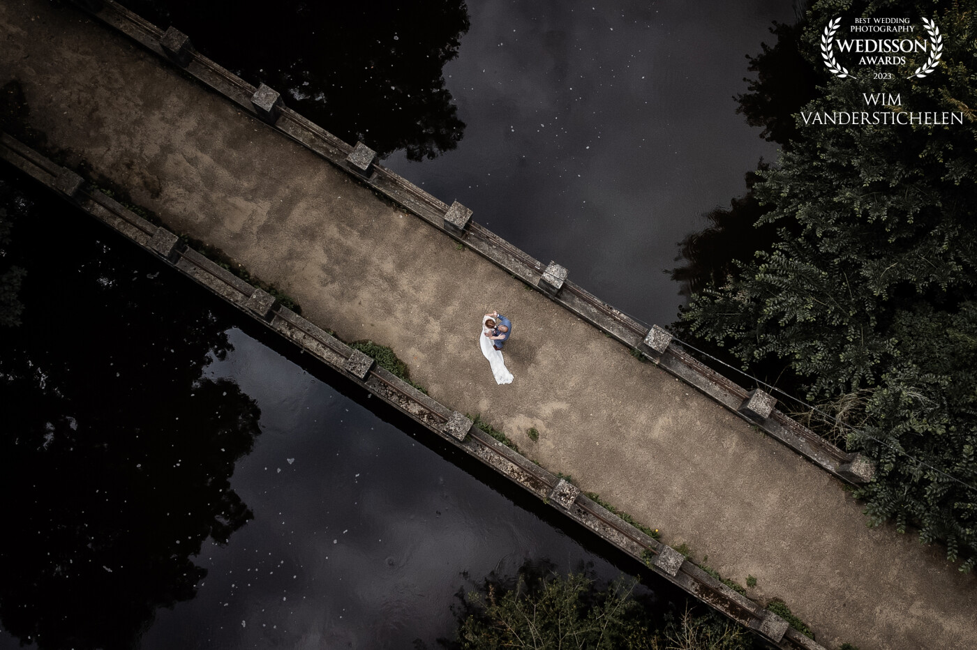 As we were walking down the bridge, I thought it would be fun to take the drone up for a flight. The bridge was splitting the image in half as the couple was practising their first dance.