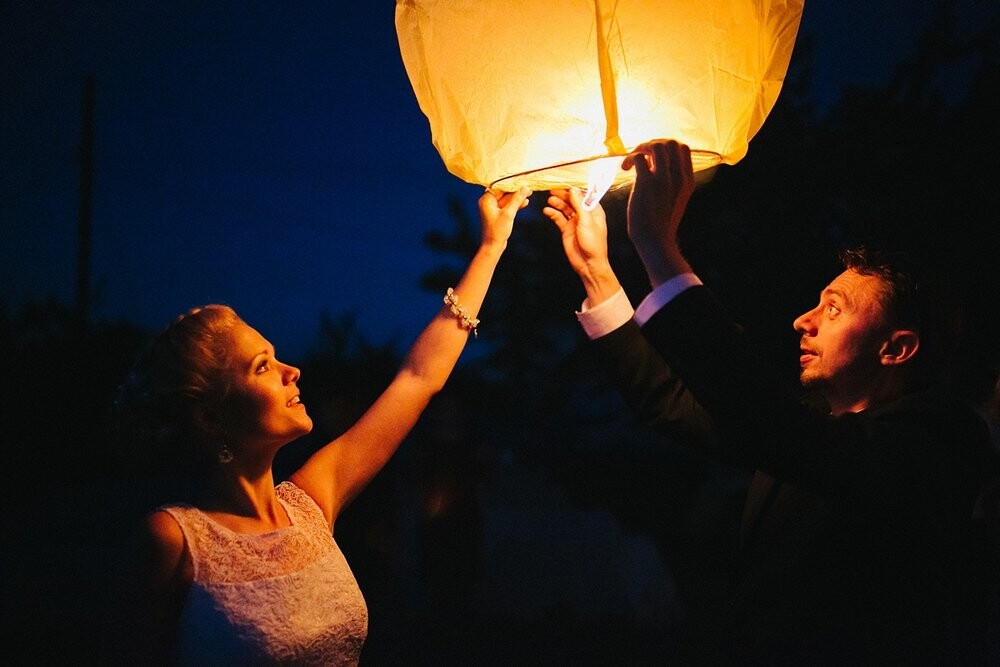 It was taken in Gomel at groom's place. When almost all the guests had left the party Bride remembered that she had a Chinese lantern and decided to launch it into the sky. It took almost a minute to heat the air inside the lantern. The picture was taken a few seconds before the lantern flew.