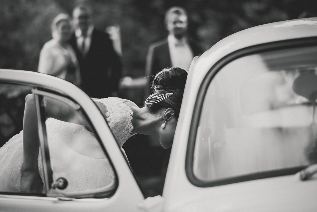 The day was mystical, weather changed in every half hour. It was raining, sun was shining, it was raining...a lot, then it was shining again. This shot is taken in front of the church, right after wedding ceremony and bride is getting in to extremely beautiful old Volkswagen Beetle.