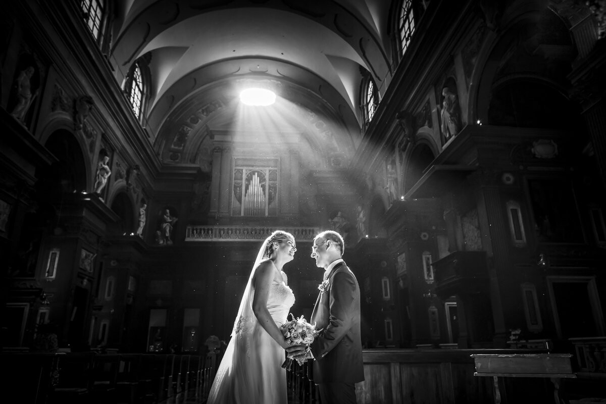 A hot summer day in the heart of the historic center of Florence. The ceremony began. I followed the imperious light beam entered in the Church, pushing it with my eyes; it arrived until that point, where I wanted, how to bless Andrea and Francesca... so I shoot this photo!
