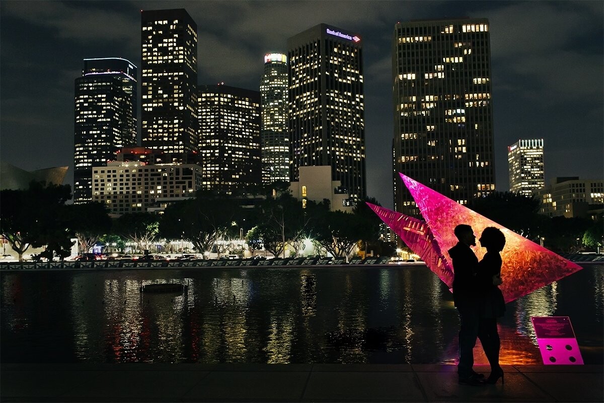 A night time city view of downtown Los Angeles for a romantic couple who first met on Facebook when it was mainly for college students.  This social networking relationship began as friends and turned into companionship and love.  Congrats to them as they cannot wait to tie the knot.