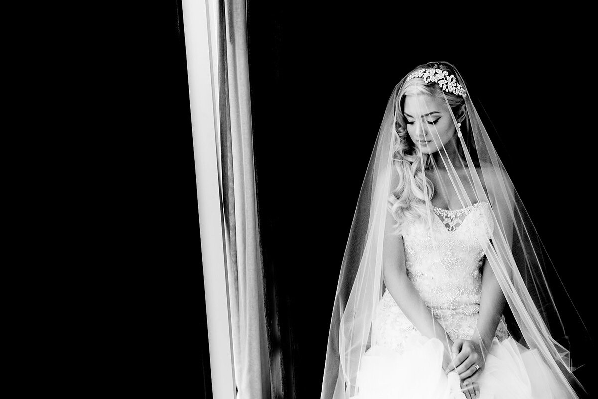 Although it was raining like crazy on a summer day in Seattle, this bride was picture perfect beautiful, and looked so timeless with her veil over her face right before she saw her groom for the first time on their wedding day.