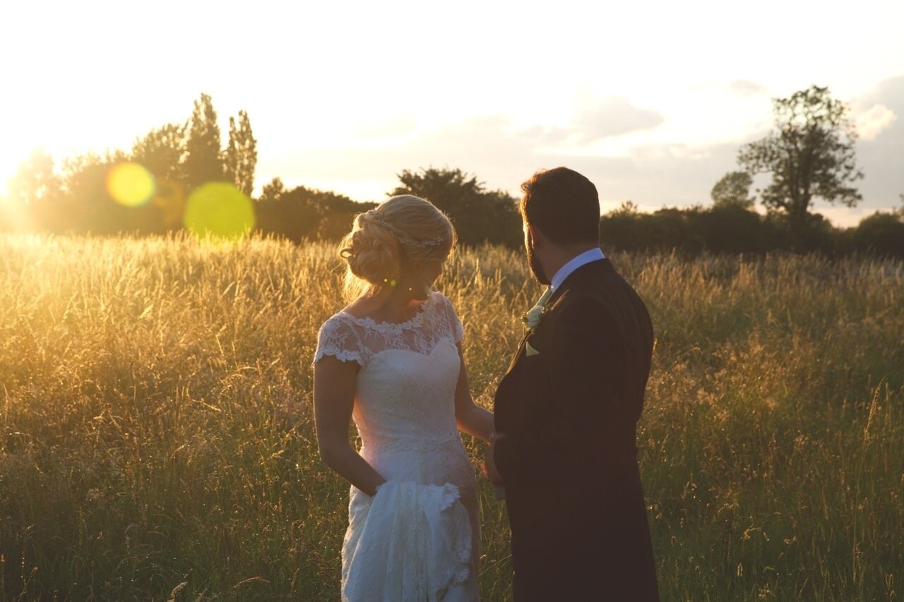 My approach to documenting weddings is to combine nature, light and emotion to create atmospheric photographs. This particular photograph encapsulates all those elements together. Lottie and Joe got married in July 2015, in the beautiful countryside of North Yorkshire, United Kingdom. After a typically rainy British summers day there was a break in the weather and the sky opened up casting this beautiful early evening sunlight across a nearby field. I managed to sneak the bride and groom out of the marquee, and captured this magical moment between the two of them.