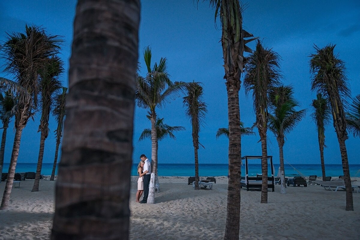Allister & Genevieve got married in Cancun, Mexico. The weather is usually great in Mexico, but you never really know how it is going to turn out. Only 15 minutes before this photograph was captured the sky was completely dark and it was raining heavily. We all prayed the storm would go away and it did for a brief moment. We had a very short window of opportunity to capture this image. The sky was perfect, the light was great, the scenery was beautiful and magic happened.