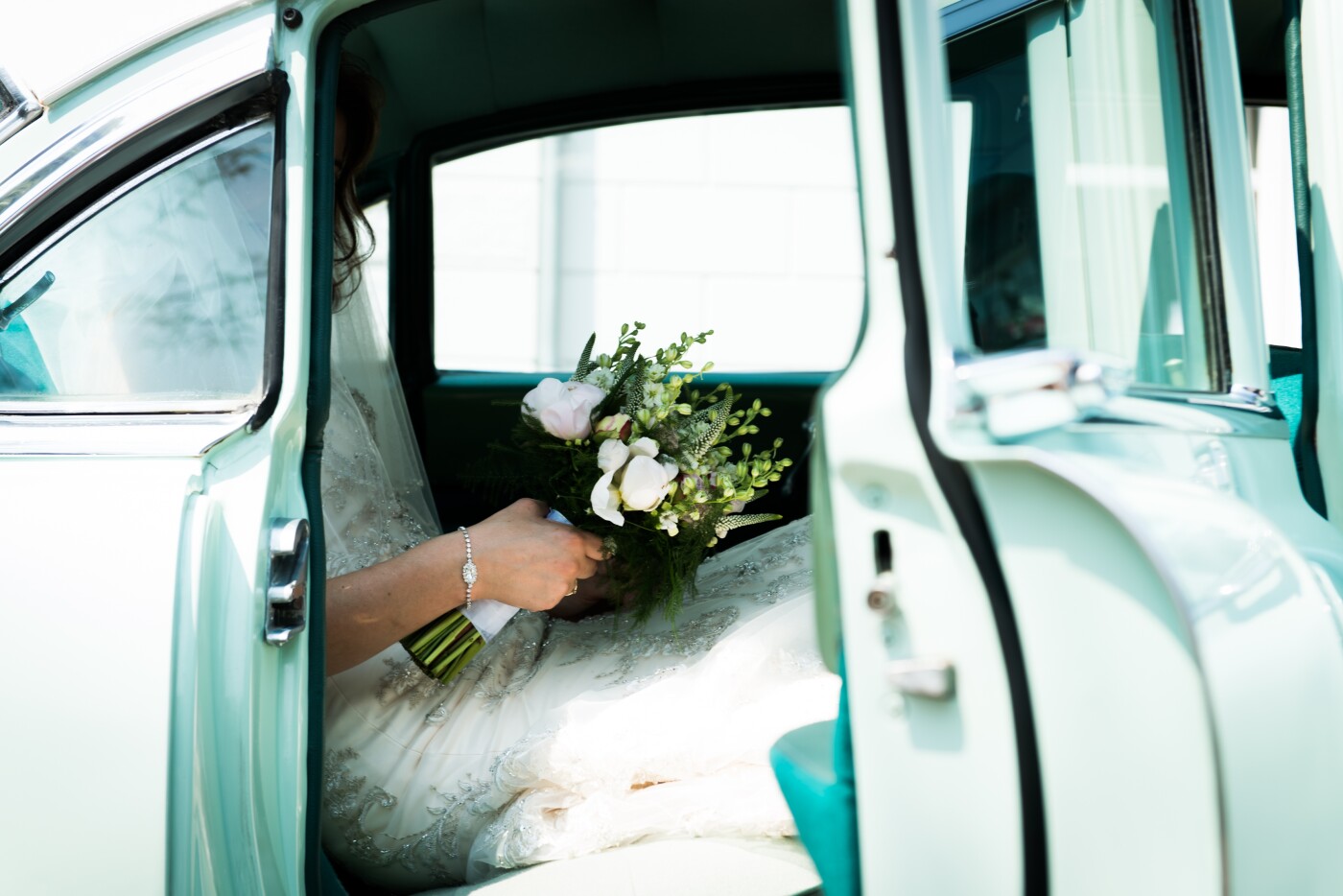 Everybody was in the church and the groom was waiting for his bride. I quickly went outside and to this picture of her, waiting for her dad in the classic weddingcar.