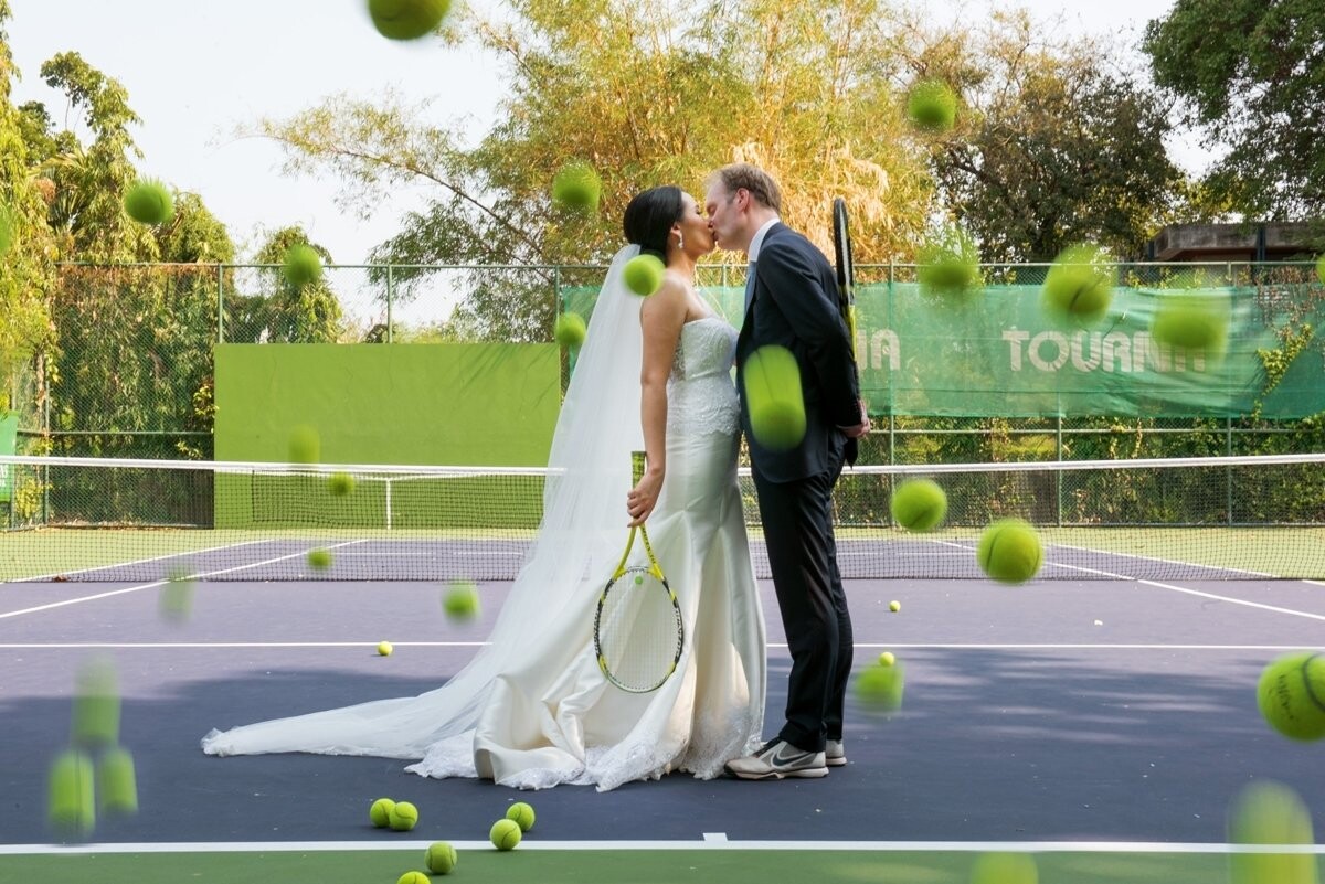 The bride as a tennis player. Also,The groom was like playing tennis. I think they both deserve to have wedding photos at the tennis courts as a souvenir. Of course, it needs to create something that is unique to the image. Using tennis balls make as the rain falls. It would seem strange and attractive, not less.