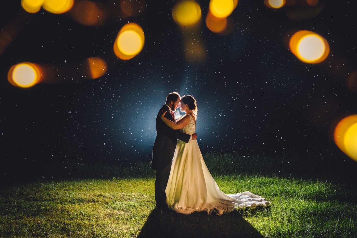 Alex & Charlie were a dream couple and up for any suggestion I had for images. The wedding was at Bordesley Park which offered so many locations for shots and we came away with loads of great portraits. Towards the end of the night the rain started and I knew I wanted to try a backlit image. I introduced some fairy lights to give some interest to the top of the frame, grabbed a bridesmaid to act as a human light stand and the rest is history.
