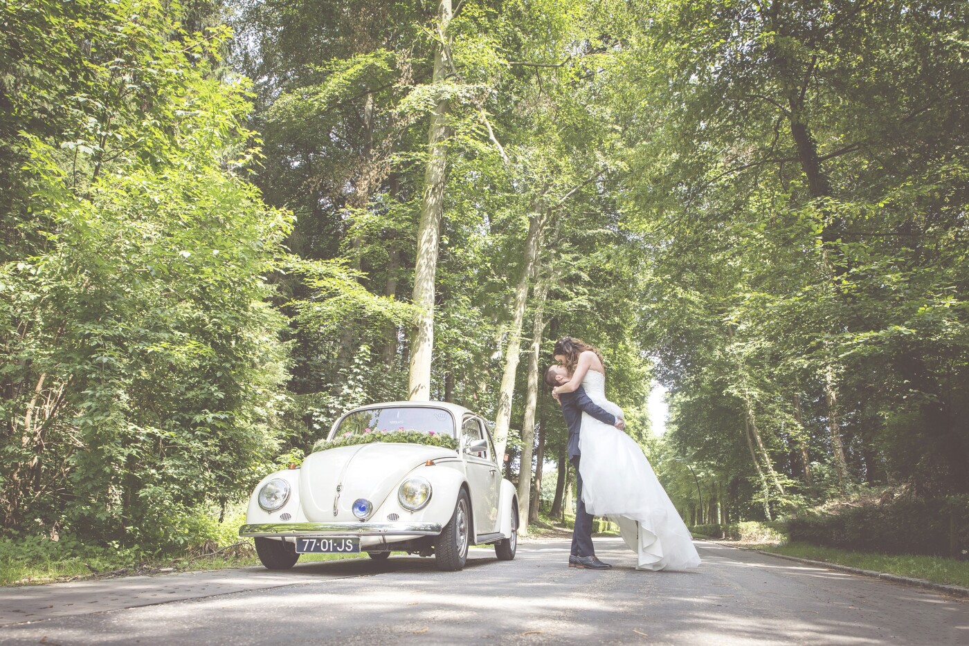 This was the big day of Nathan & Anke and this is probably one of the pictures I loved the most of their wedding.<br />
It was shot in the Netherlands on our way to their party location, one of those perfect spots.<br />
The lighting was perfect, the car being cute and the couple not paying to much attention to me.
