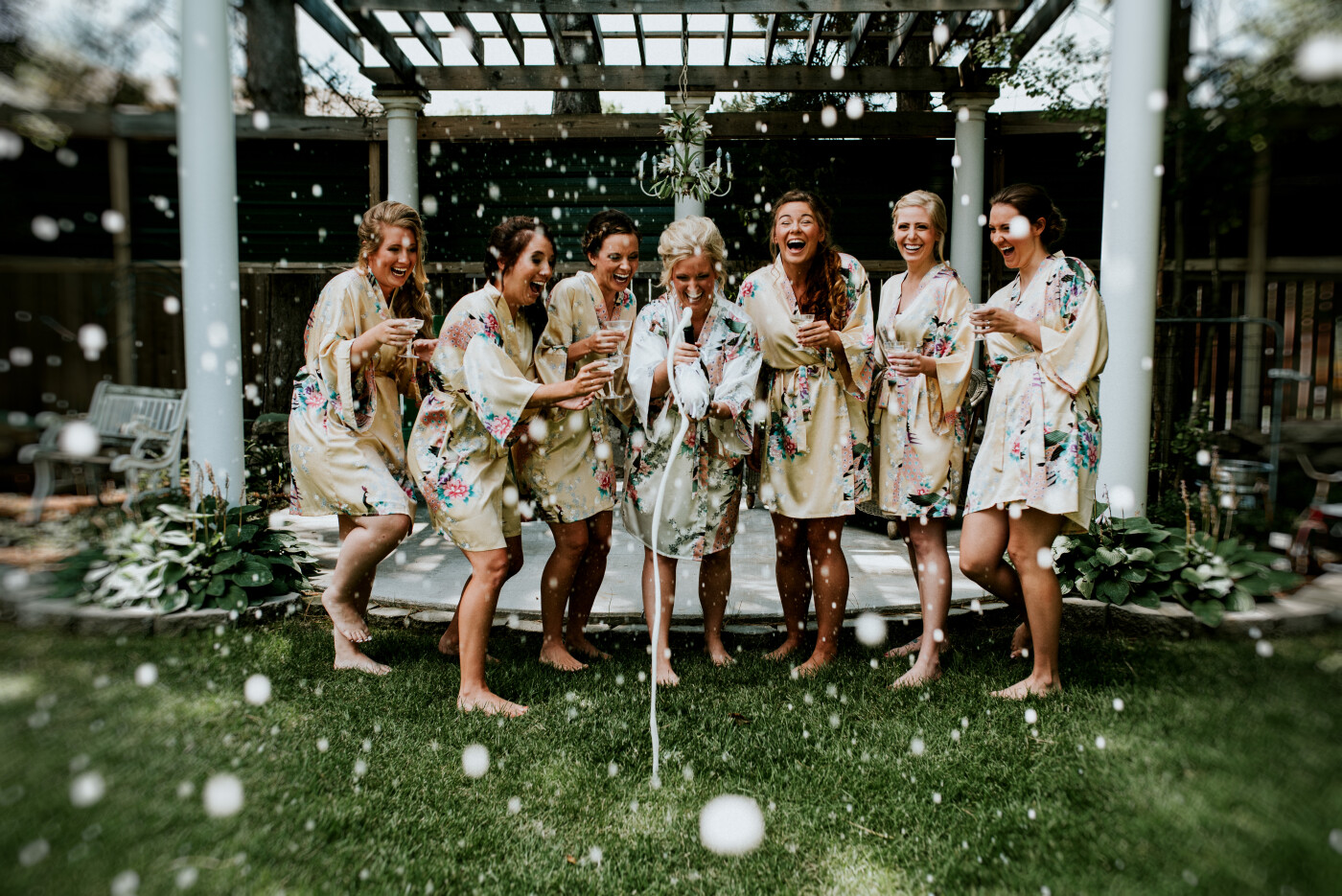 This bridal party was so much fun getting ready!  I hung out with these ladies at a bed & breakfast while they got ready for the wedding.  The bed and breakfast had this gorgeous backyard.  I said "Let's have some fun before we have to get all serious in an hour!"  I grabbed the pottle of champagne and told her to shake it as hard as she can, and we got this incredible explosion of bubbles.<br />
