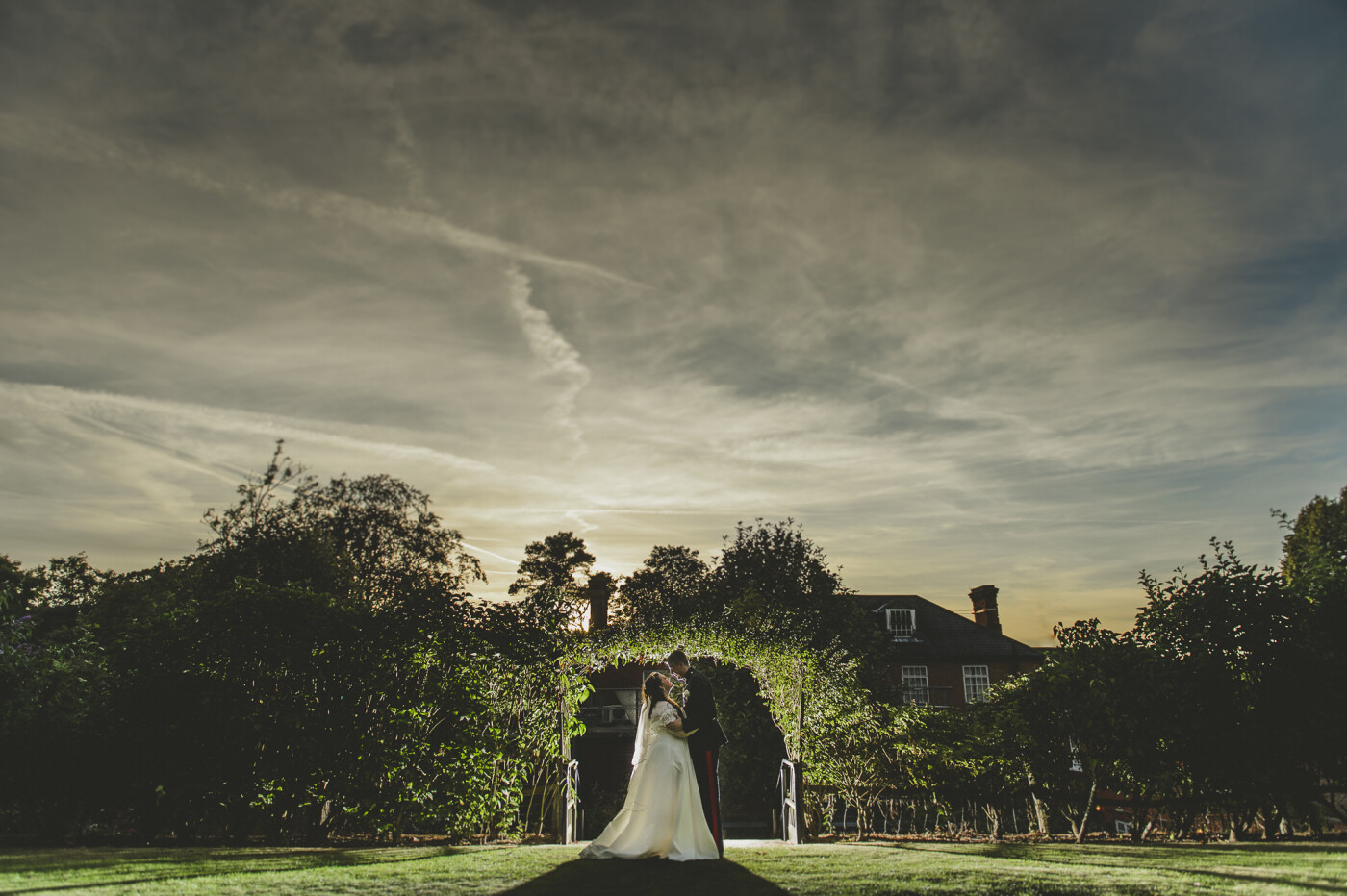 At  recent wedding at Brandhatch Hotel, we managed to sneak the bride & groom out at sunset, set a light up behind the couple and tried to balance the sunset above the building, trees with the flash light. With the aim to produce a stunning WOW shot for the couple. Hopefully we pulled it off.