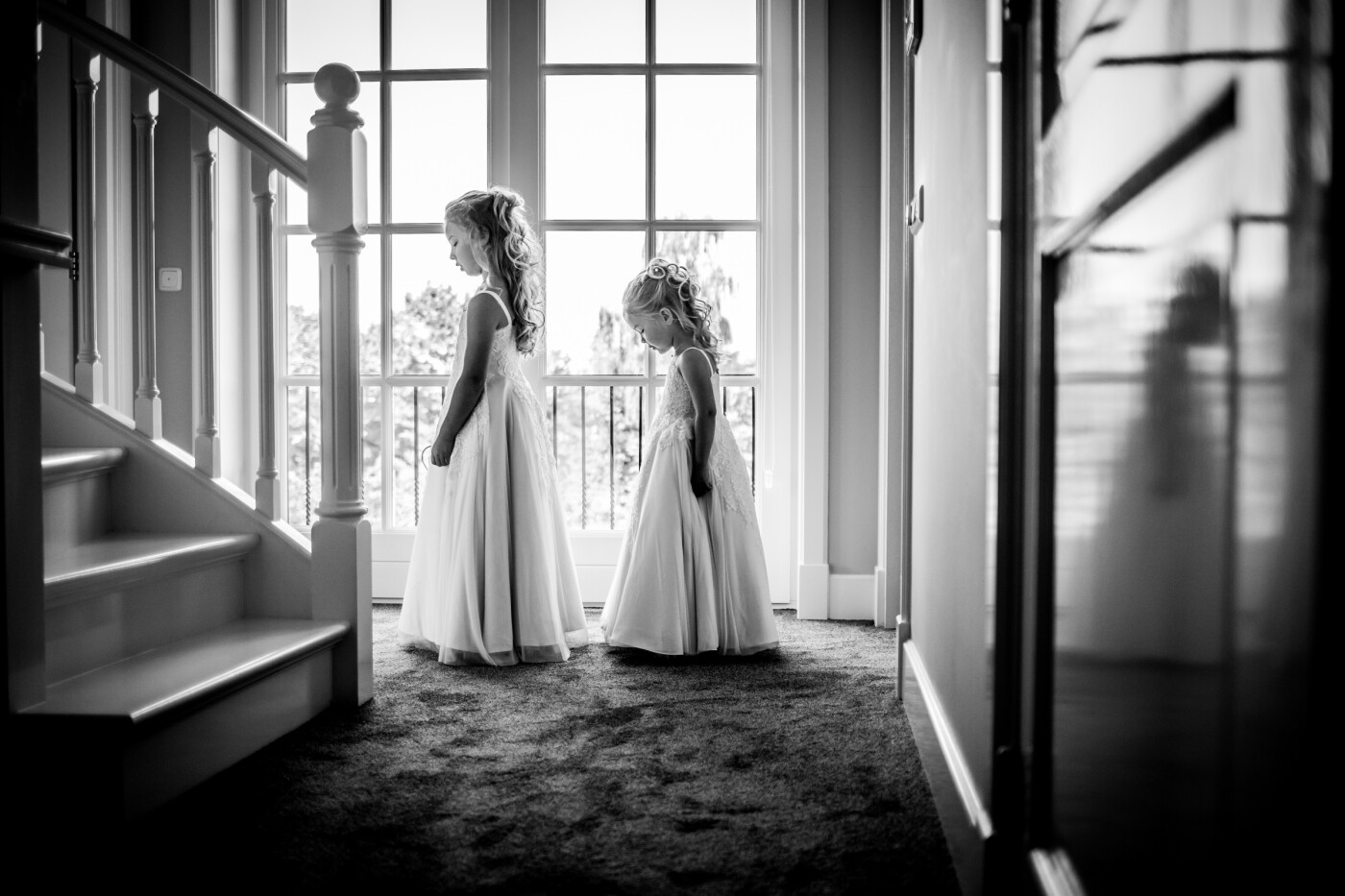 Two little Princesses <br />
<br />
These two little princesses had the exact same dress as their (bride)mum. The house where the preparations were being made for the weddingday was absolutely stunning. I was sitting in the hallway just waiting for a magic moment to happen as I knew the girls would come out of the room and show their precious-one-day-in-a-life dress to everyone. I loved the surroundings, the light, and these two beautiful girls. 