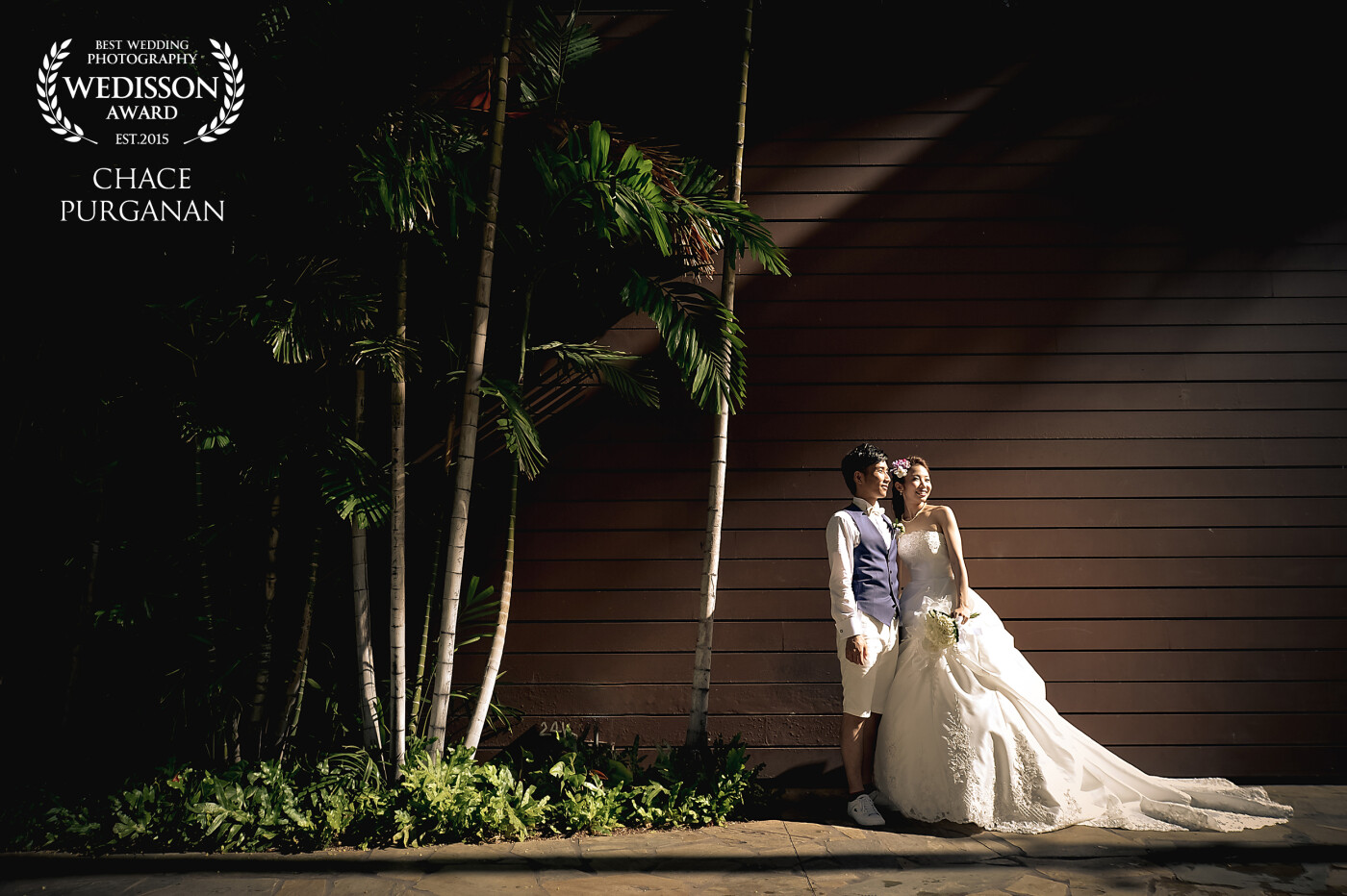 While walking through the Royal Hawaiian Shopping Center in Waikiki, Hawaii I saw the light falling ever so gently on the wall.  The two look off towards other shoppers passing by in amazement of the beautiful new husband and wife.