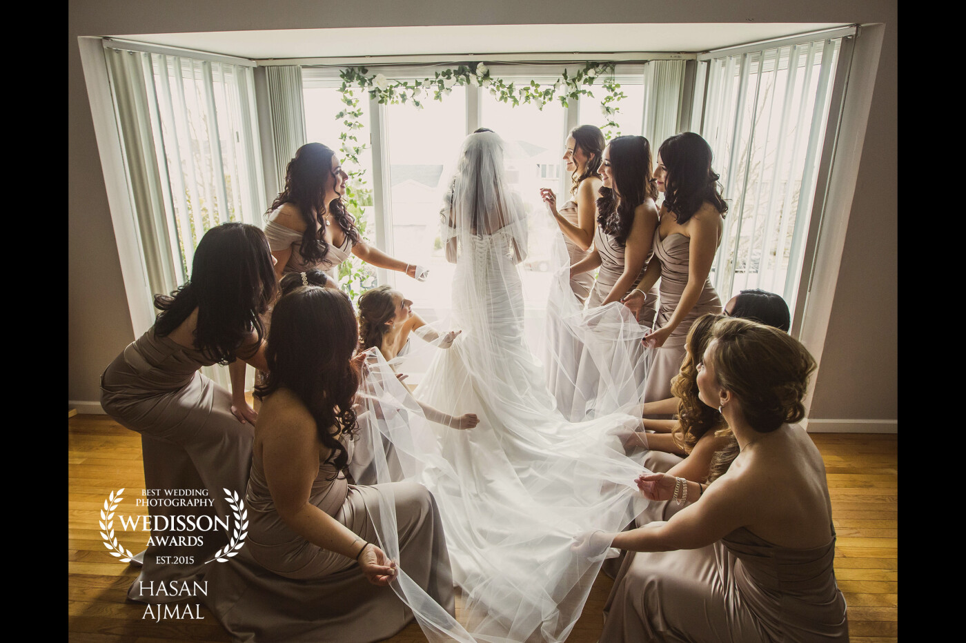 This shot was taken as the bride was by the window showing her bridesmaids her wedding dress and her veil. I loved the way the light was coming from the window and had to snap a shot of them in this moment. 