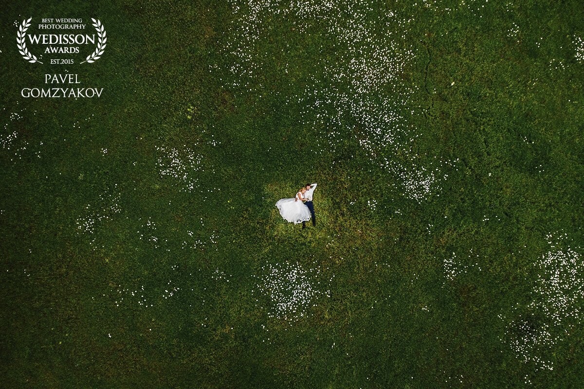 This image was shot in the foothills of Mangup Kale. Green juicy grass and white daisies are the perfect bed for the newlyweds. Mikhail and Tatiana inhale fresh air. Their sleep undisturbed. Harmony!