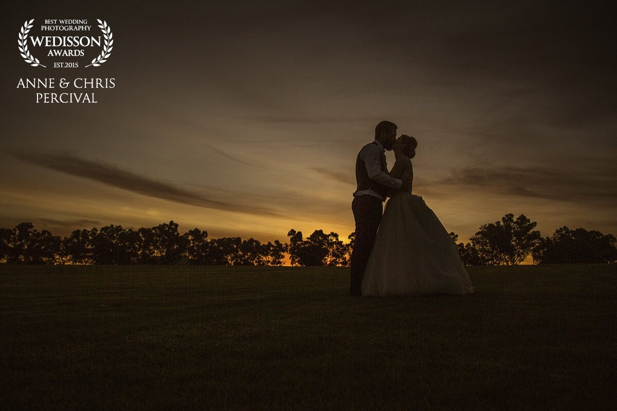 We captured wedding images for Bec + Maitland back in November of 2016. A truly beautiful couple. We went outside from the wedding reception to see if the sunset would do anything special. After waiting only about 10 minutes, the sky lit with a beautiful golden glow. We grabbed a couple of images during that 30 seconds of awesome - this is one of the shots that resulted.  Our couple loved it.