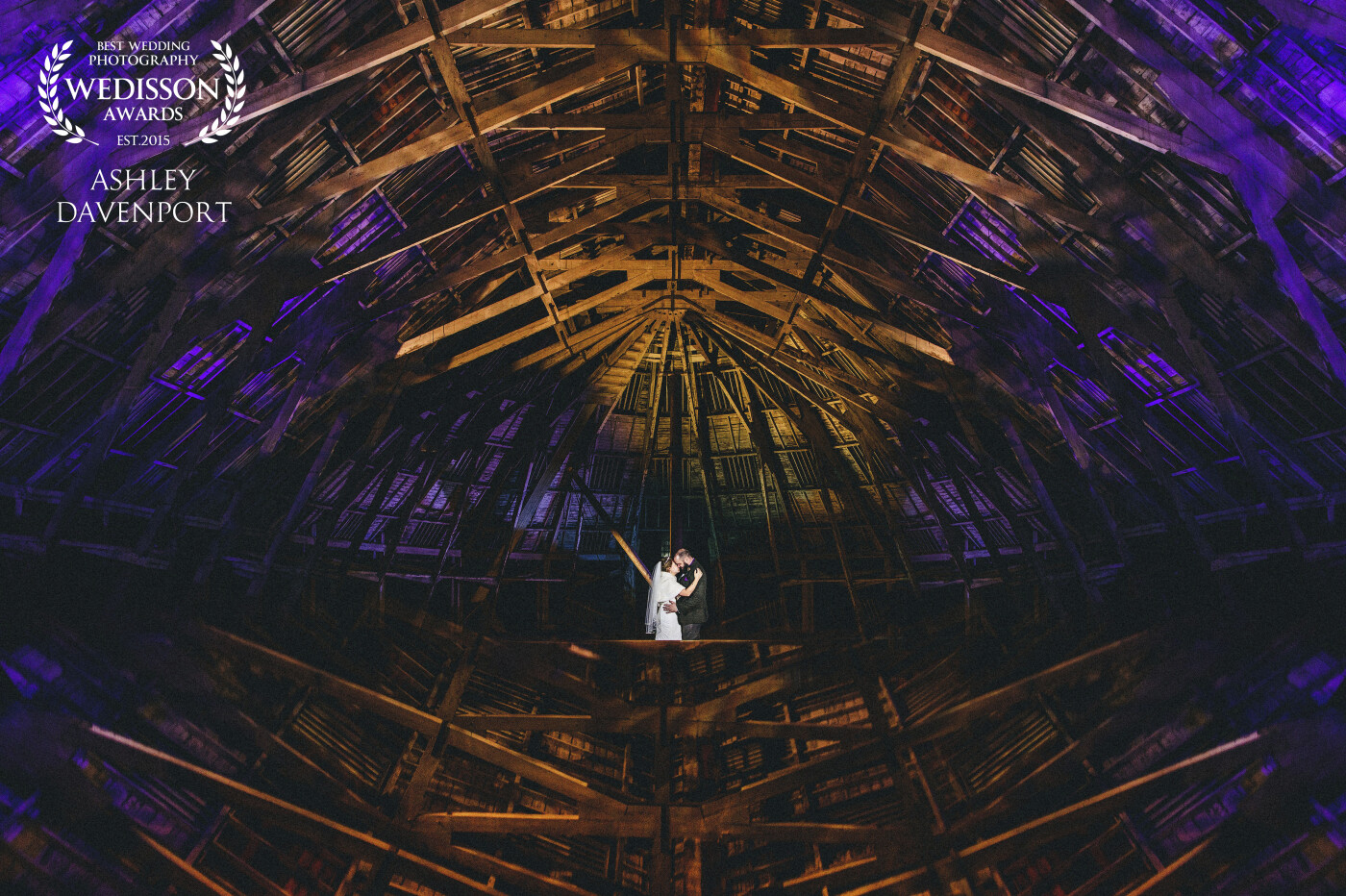 Abi and Pat got married at the Chatham Historic Dockyard (yes, this image was taken inside the venue), we had 5 minutes to grab an image of them just after the service. I saw the lights on the roof of the dockyard and with a handy reflection I managed to capture this.