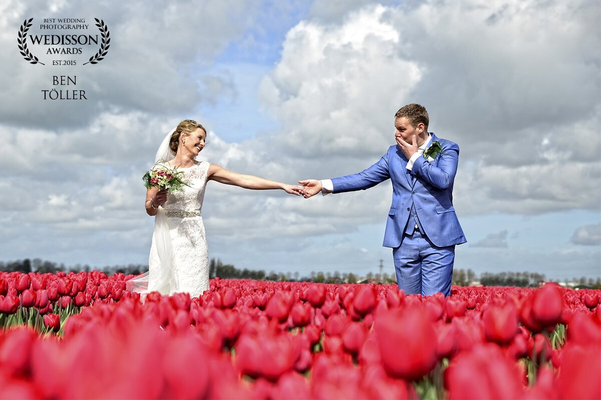 Wedding with Tulips, can it be more Dutch. April 2017. How bride & groom look to each other. The hands, the clouds..everything was in place for this beautifull picture. Another happy couple.<br />
@ben_toller_weddingphotographer