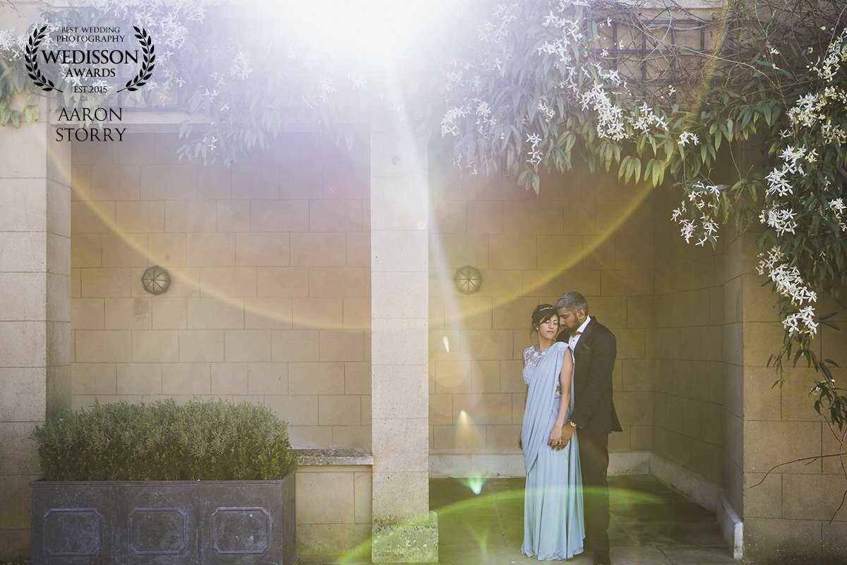 My first wedding of the year was documenting the wedding of Ushma & Dasal at the gorgeous Woburn Abbey Sculpture Gallery in the UK. As we reached the end of their portraits the sun was starting to dip behind the abbey and I noticed this amazing opportunity to create a flare. No photoshopping was use in creating this image, just a Canon 1Dx and 24-70mm :) 