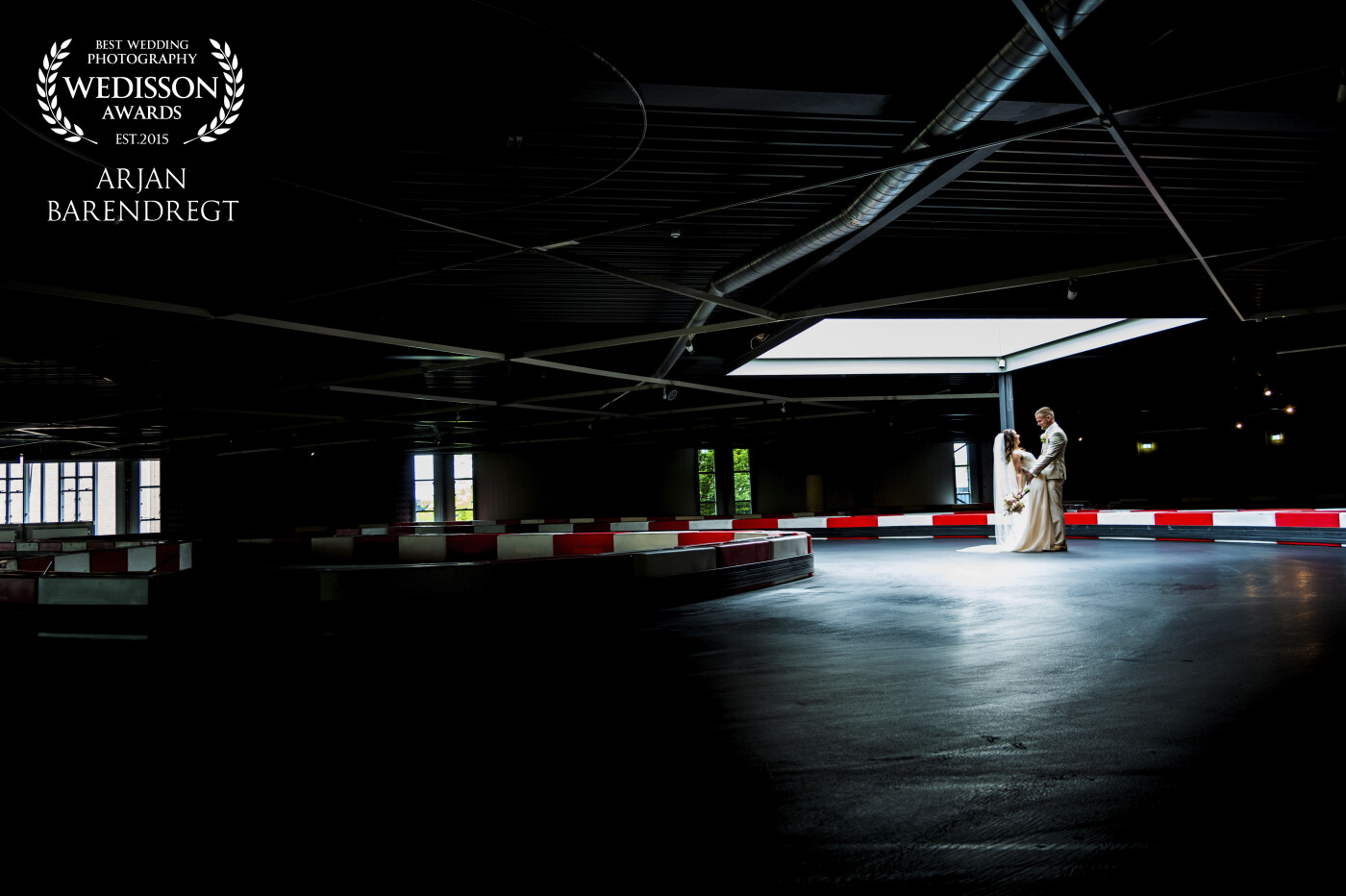The wedding couple wanted something different during the shoot and took me with them to a kart track <br />
They not only wanted the standard pictures in nature. And I was really surprised of the possibilities this location gave me. <br />
Only a few lamps were burning and so we had to use the only light spot there was in the ceiling. <br />
