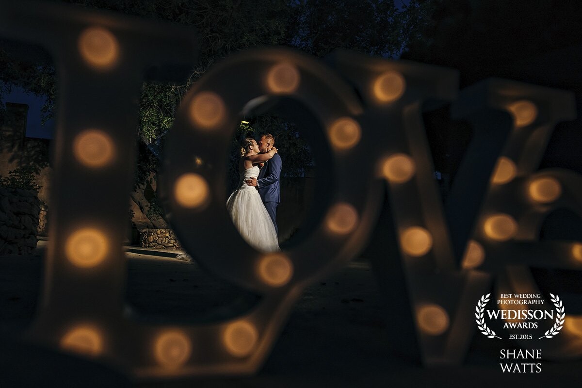 This photo was taken while Beth & Craig where having their first dance. The LOVE Sign was part of the cake table decoration and I decided to shoot through it for a portion of their first dance to add more ambient light to the scene.