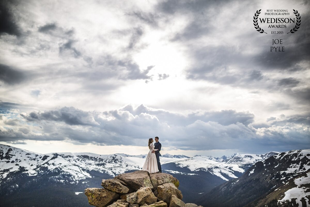 Living in the midwest United States where it is relatively flat, Katie and Michael wanted to do something special for their after wedding photos here in Estes Park. Rocky Mountain National Park surrounds our town and has many places to pull off and walk in a bit to create amazing images. These two told me before we met that they were alright with being a little dangerous on their day, so I took them here and placed them on a few boulders that stand nearly 1000 feet above the valley floor. 