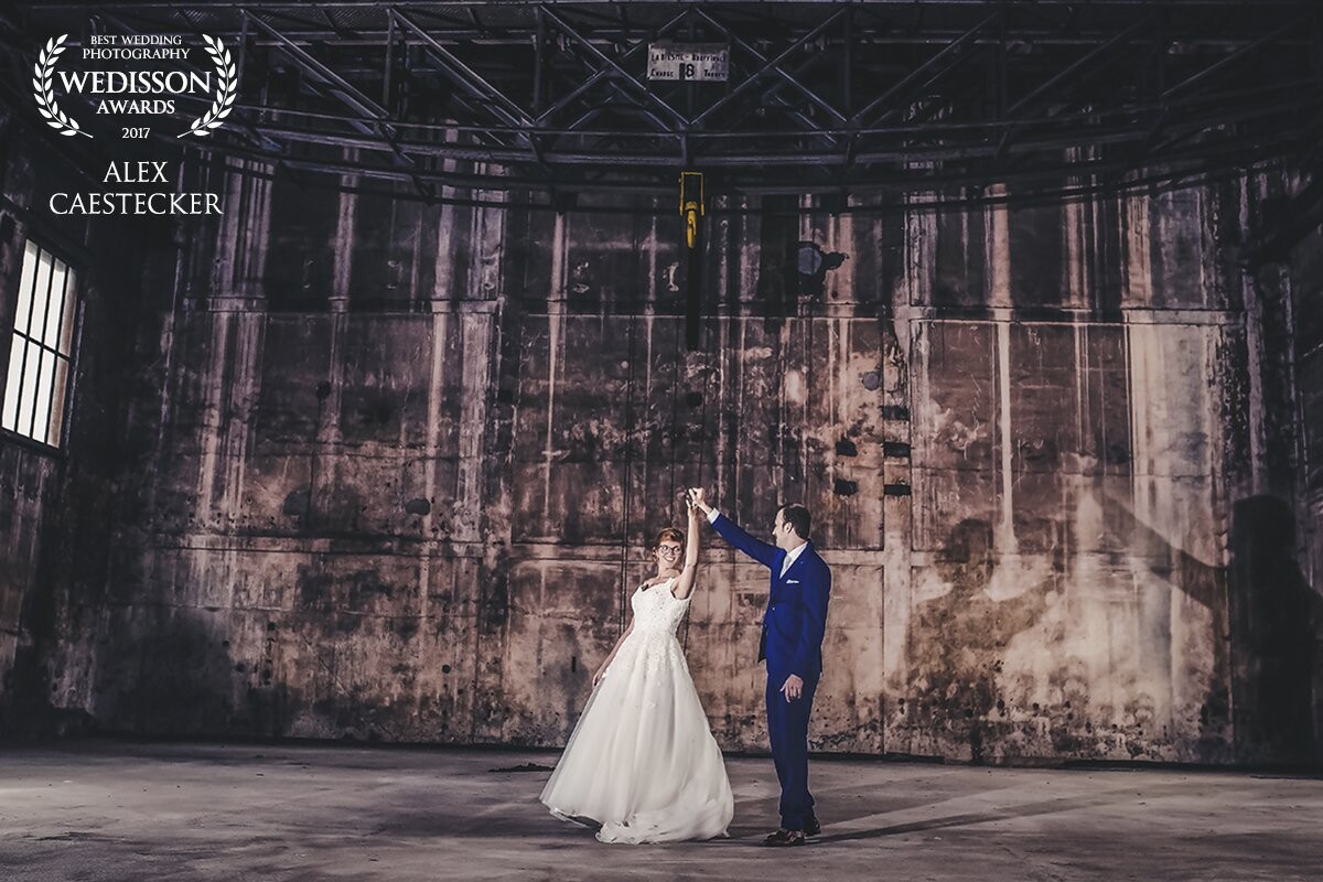 Because it was raining on the wedding day of this couple, they had chosen for an old abandoned factory.<br />
And we were so grateful for this rainy day: what a amazing place!<br />
Not an easy job due to the lack of light. With a little help of the magmod and controlling the light we were able to shoot really fantastic pictures. <br />
And this picture was by far our favorite!