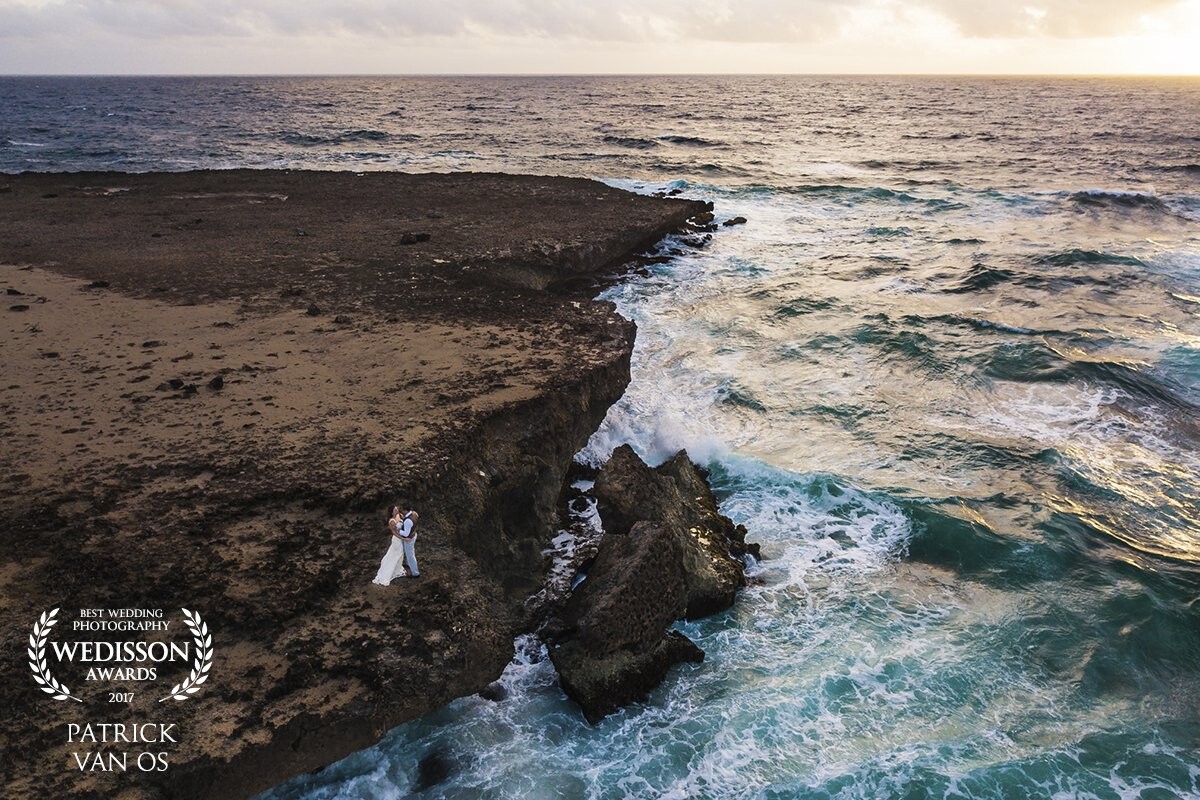 The alarm clock went off at 5 am to capture this couple at the rocky side of Aruba before sunrise. Once we arrived at the location everything was looking great. Until it started pouring rain. Unfortunately we were quite far from the car. So when we all arrive there we were soaked. Despite the 30 minute shoot I'm happy with the result an amazed by how the drone was capable of handling the strong winds.