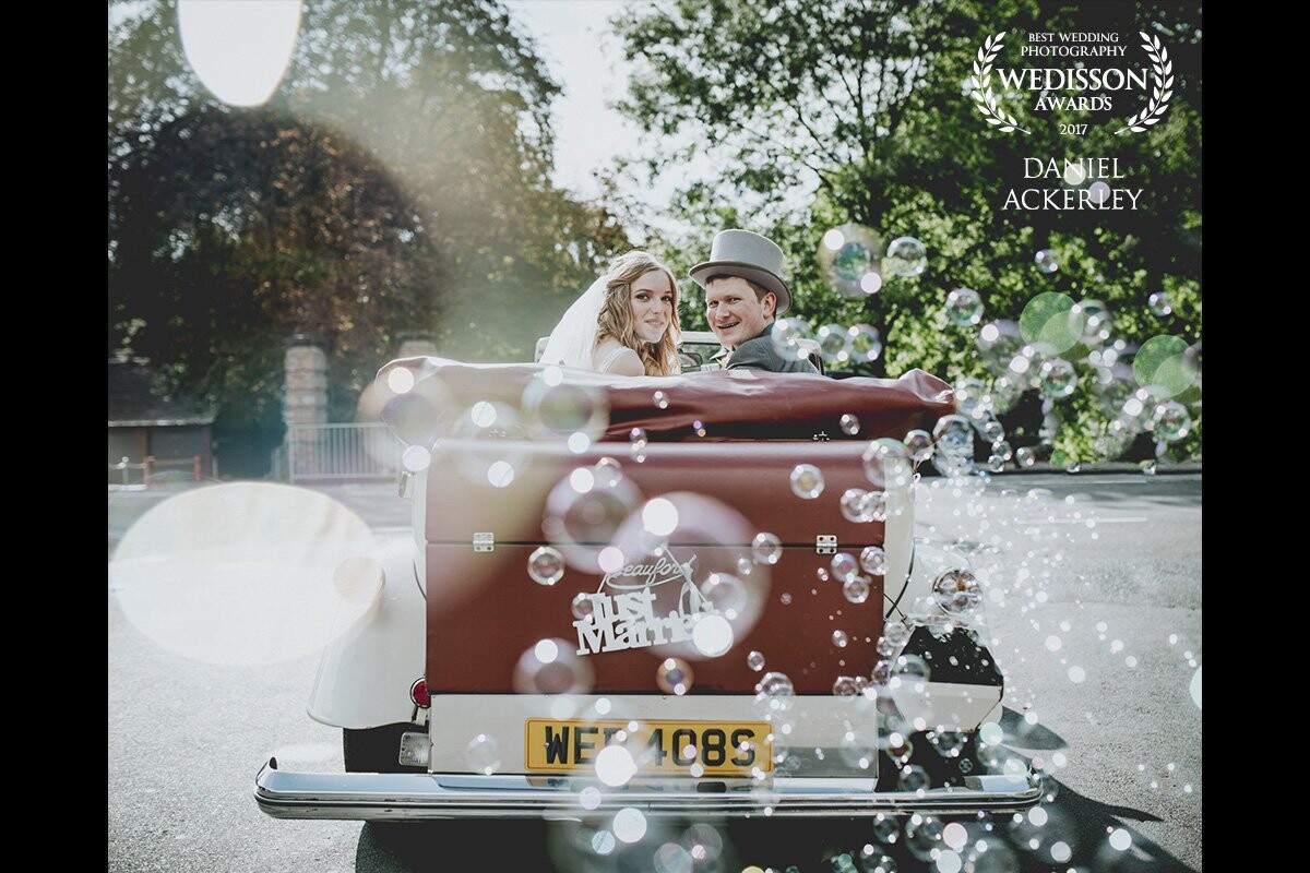 I couldn't work out why this vintage car had a box attached to the side of it's boot until Phil & Izzy began to leave the car park of the Church - bubbles just started flying out of the back of it so I ran in close just before they pulled out and I managed to capture this image!