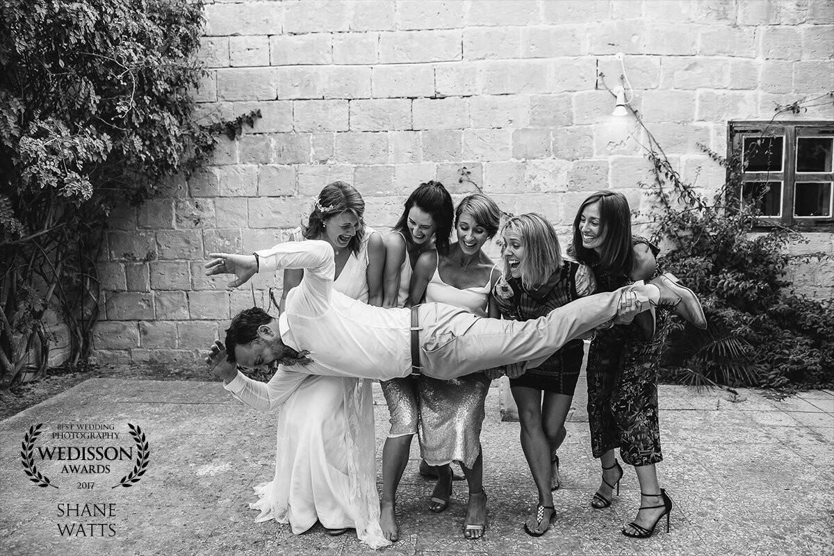 I like to ask the girls to pick up the groom for some fun photos, a bit of a twist from the traditional. Rarely has the groom ended up on the floor...but not never! 