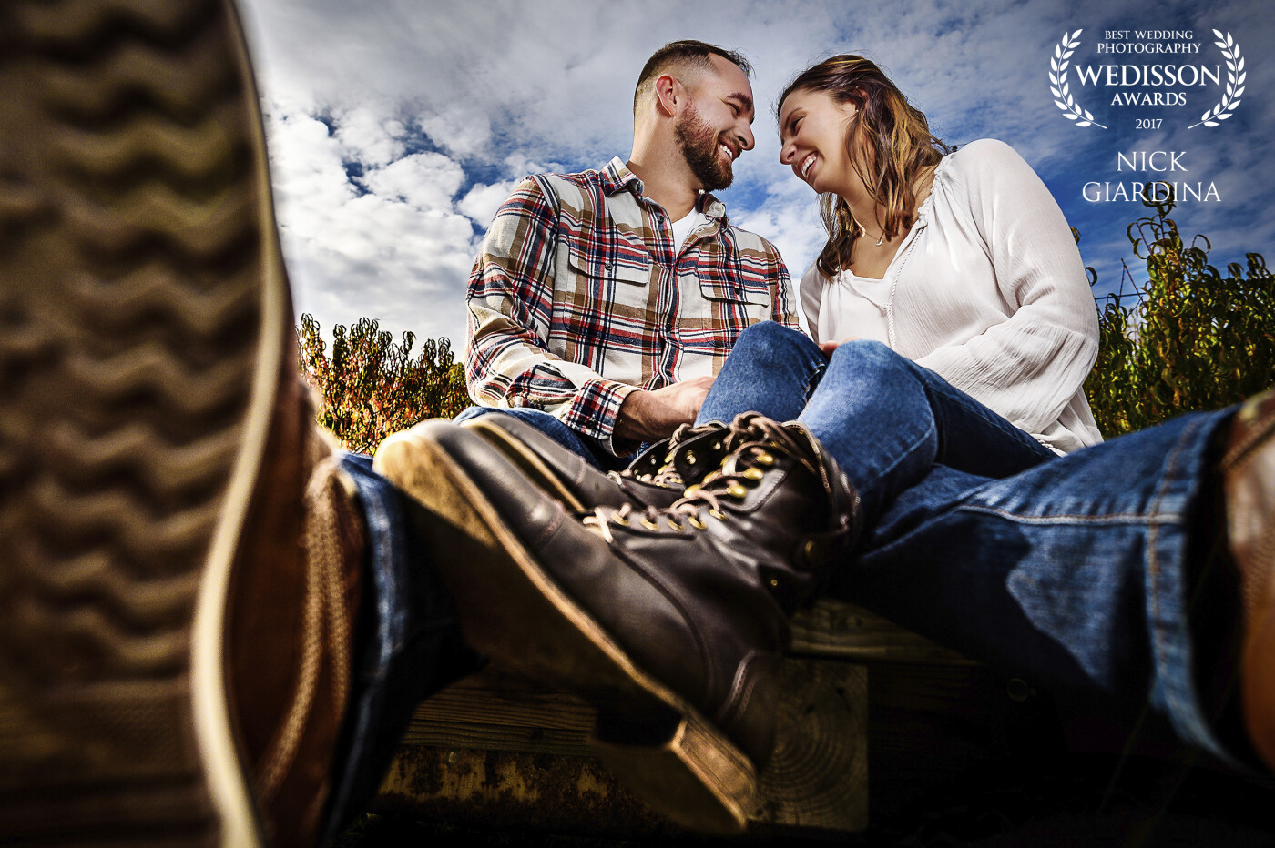 Jessica and Eric wanted to shoot their engagement session at an apple orchard that they have frequented together. We saw this really cool apple cart and sat them on it. I knew this needed to be shot super wide and close to Eric's boot. I think the final image has sole!