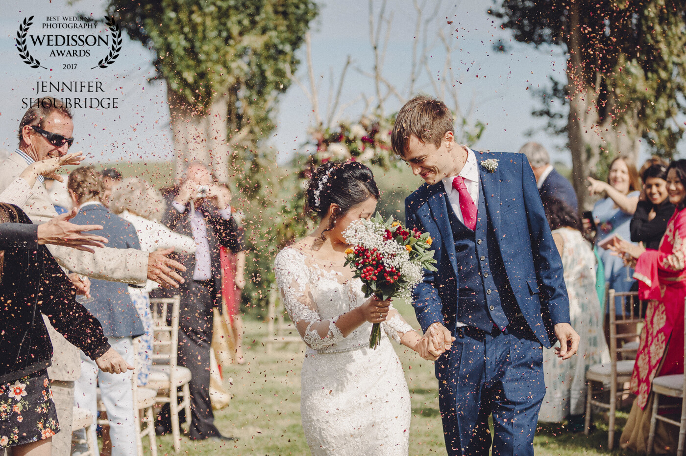 Ollie & Ichha had just got married and were walking up the aisle through a confetti throw. I had dozens of shots, but this one just caught my eye the most as they both turned their heads towards each other, using the bouquet for cover as the confetti shower got more enthusiastic