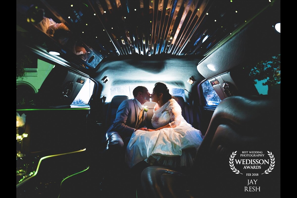 The wedding couple were very excited about their limo ride to the ceremony location. Both I and the couple absolutely love dark images with popping colors and light, so we knew something great would come from me joining them on their limo ride. The neon accents, mirrored roof, and back light made this image exactly what we all imagined!