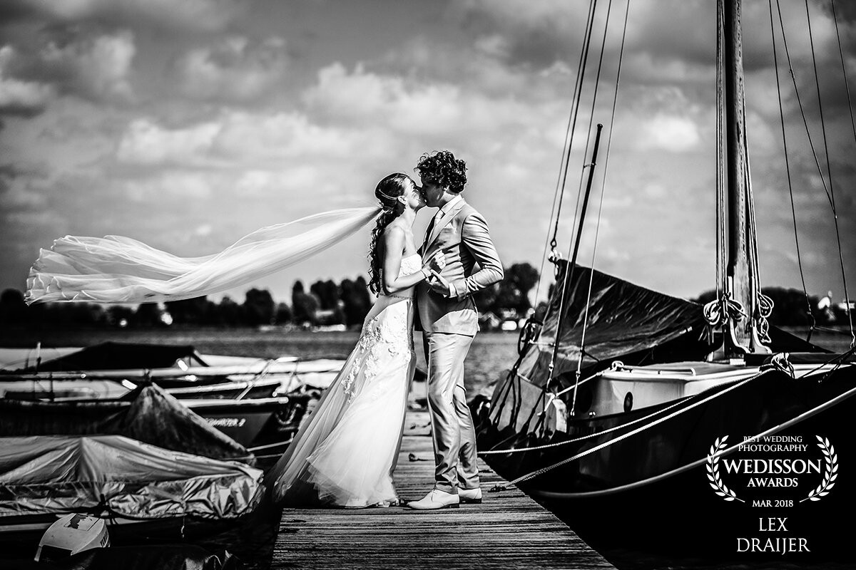 What a great day at the lake. Wind, sun and clouds, all there to embrace this lovely young couple. You can image they just arrived with the rough sailing boat on the right, spending an intimate moment in the middle of a joyous wedding day.