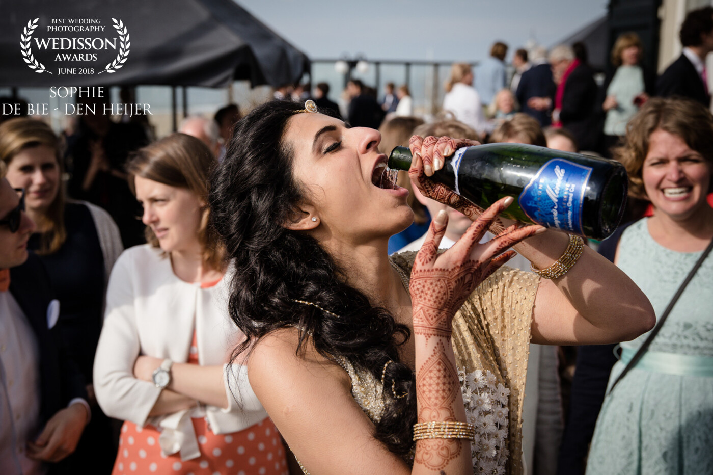 On this Dutch and Indian wedding, I captured this photo of the bride. The groom had just opened the bottle with a knife he had been given by his study friends. Since the bottle now had sharp edges, the bride went all in and poured the champagne right in her mouth. Still a lady. 
