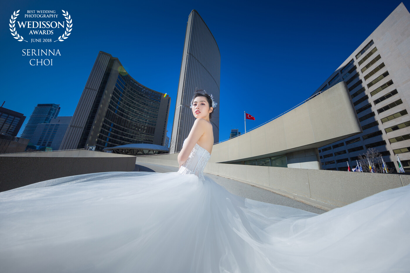This photo was taken outside the City Hall of Toronto. This is the place where people in love with each other become a real married couple. Walk in the City Hall wearing a white wedding dress, the girl's love story has entered a new chapter. 