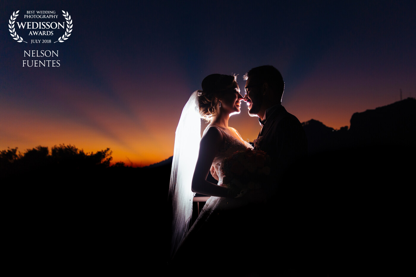 As the wedding ceremony ended I saw these beautiful sun rays hiding behind the mountains.  We had to rush with the couple to capture it. The look on their faces and the colors of the sunset made me fall in love with this moment. 