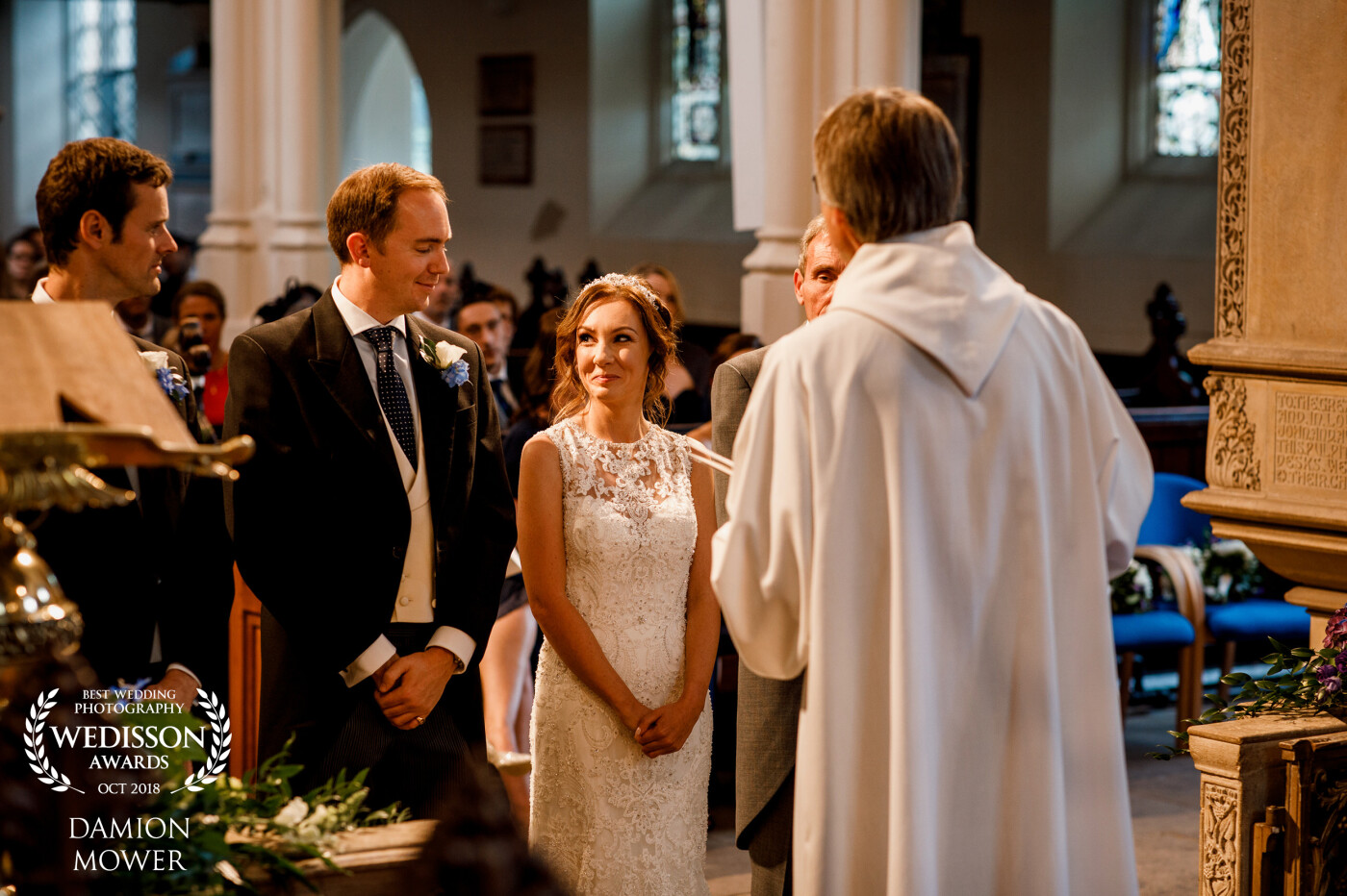 A cheeky moment between Andrea and Andrew at the ceremony - a loving and knowing glance and a stolen shot from me as the vicar told me I was not to be in front of the bride and groom! <br />
Taken in Wimbledon, South West London.