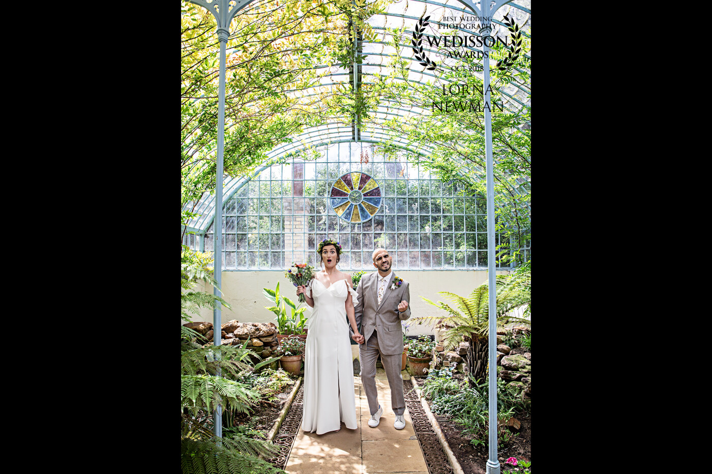 The grooms brother made his bride's wedding dress! Rainbow theme wild flowers and amazing bride & groom!!<br />
I had so much fun with Andrea & Antonio at the very beautiful Swiss Gardens & Shuttleworth House in Biggleswade. This was taken in the Swiss Gardens green house and it looks like Antonio knew this image would win an award! 