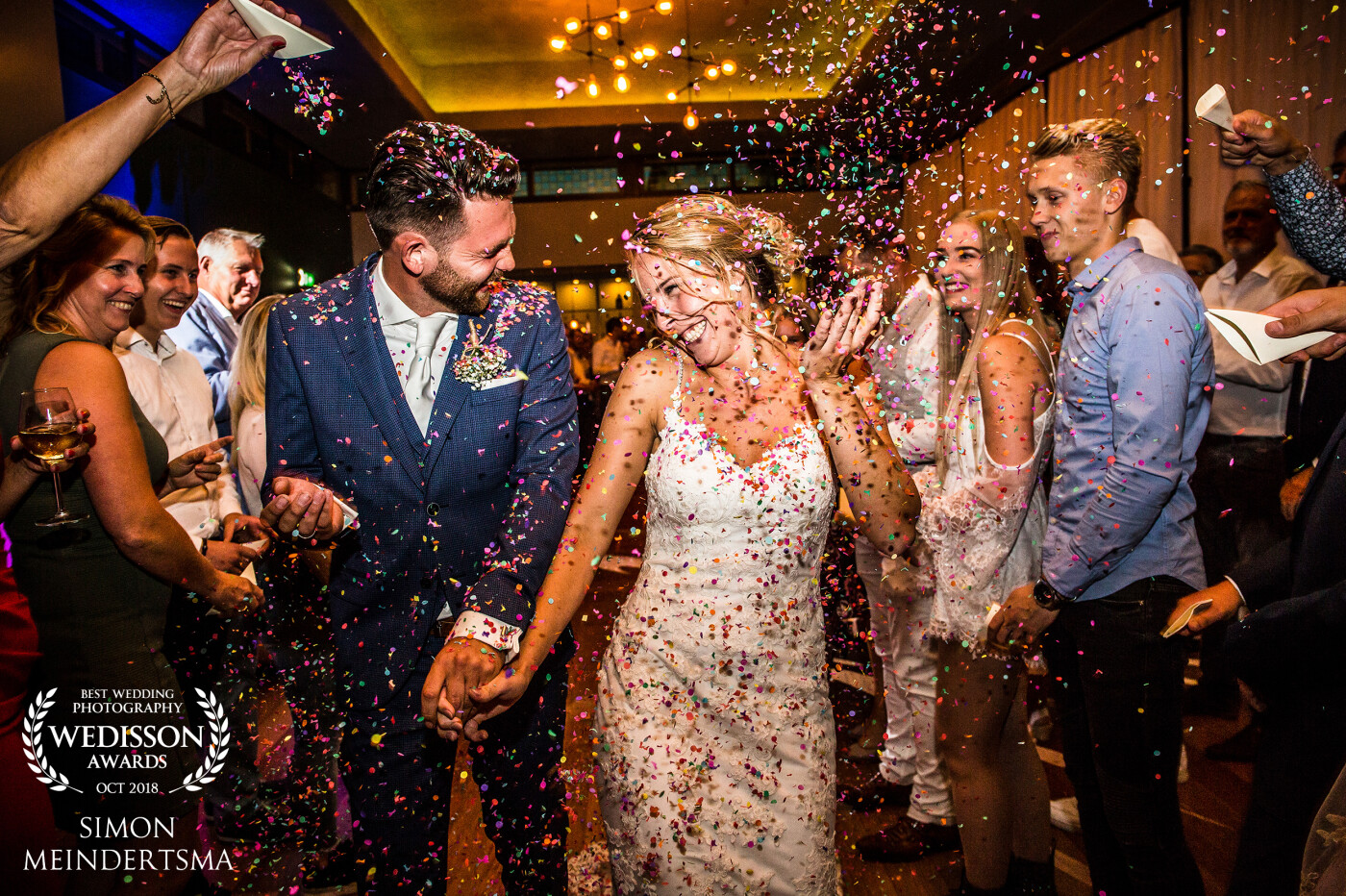 This image is a the start of a really great party with lots of young people.. Through an aisle of people with confetti i just walk backwards in front of them keep shooting lots of pictures.
