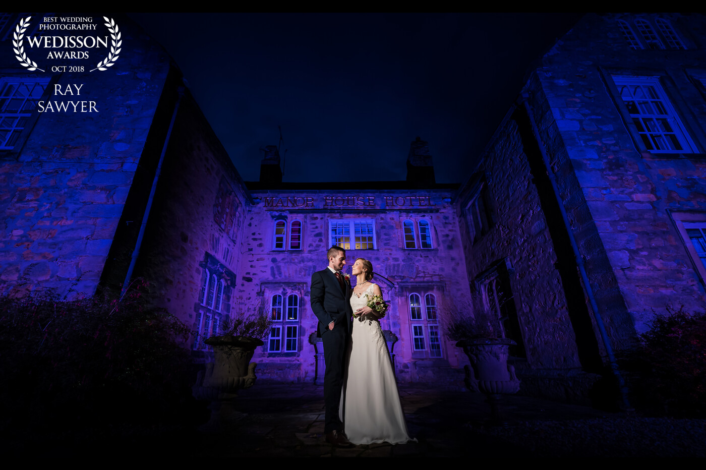 Love the colour on this photo. The couple chose the purple to reflect their wedding. Photo shot at 14mm for dramatic effect. Purple gel firing into building behind the couple and then moved to the left and right for the sides. The sides were then composited back in so the entire building was purple.
