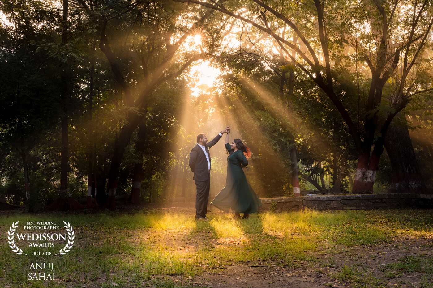 In India, one of the biggest challenge is to find a good place without people. I went with the couple early in the morning to a park with the same intention. When we started the shoot at 730am, the park was lit by beautiful golden light of the rising sun. As I was photographing the couple, I saw this beautiful sunlight light peeking through the trees and immediately i knew i have to capture a dancing pose of the couple under the sun's golden spot light!