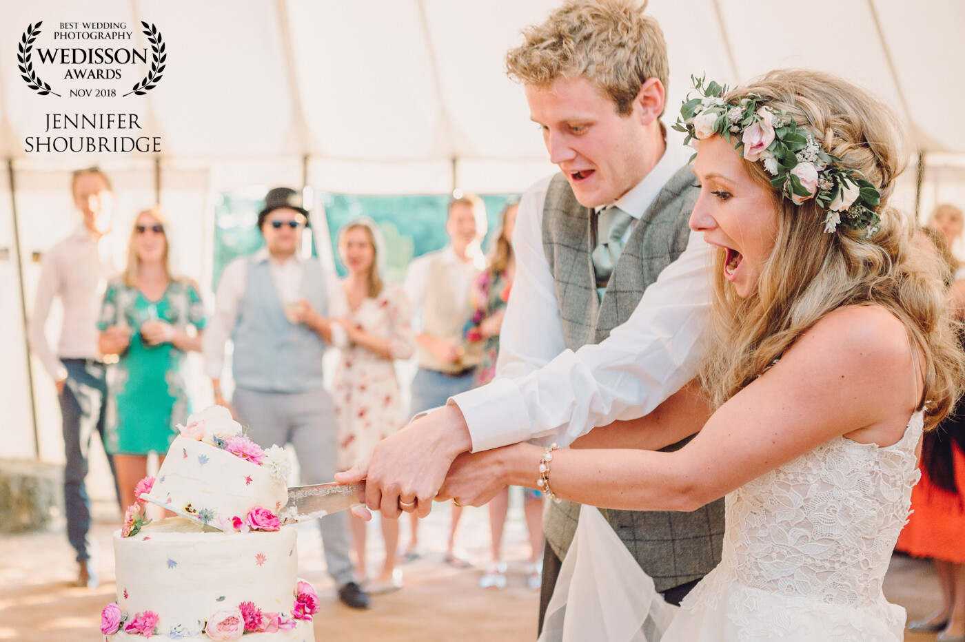 It had been the hottest day and the cake although brought into the marquee and assembled later in the afternoon, was starting to feel the effects of the day. As Rosy and George cut into the top tier of the cake it started to lift up and almost come off. This shot is their expressions as it happened.