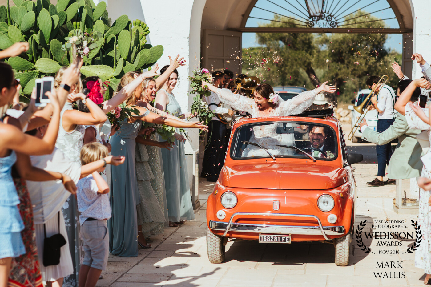 I've seen some brave attempts to limit the carnage caused by confetti, but none as bold as this couple's approach. With a wedding at Masseria Potenti in Puglia, Italy what better way to run the confetti gauntlet than in a vintage Fiat 500?! Obviously there was a lot of faith placed in the groom's ability to control his right foot when standing in my usual spot in front of the approaching couple!
