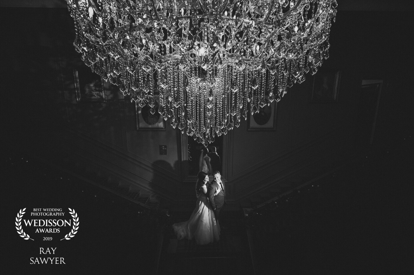 I created this image with the intention of being a Black and White with the huge chandelier above. <br />
They were lit from a key light on the floor below and a light upstairs firing into the chandelier.
