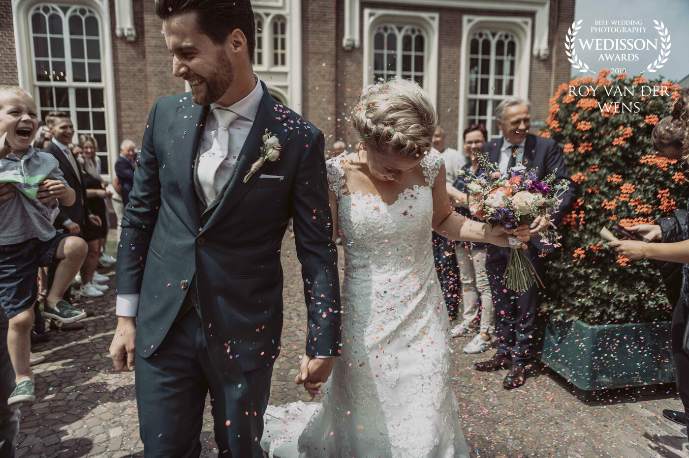 Lovely dutch wedding couple is covered in confetti by friend and family. <br />
This couple is from Udenhout that is in the south of The Netherlands had an amazing wedding day with friends and family.