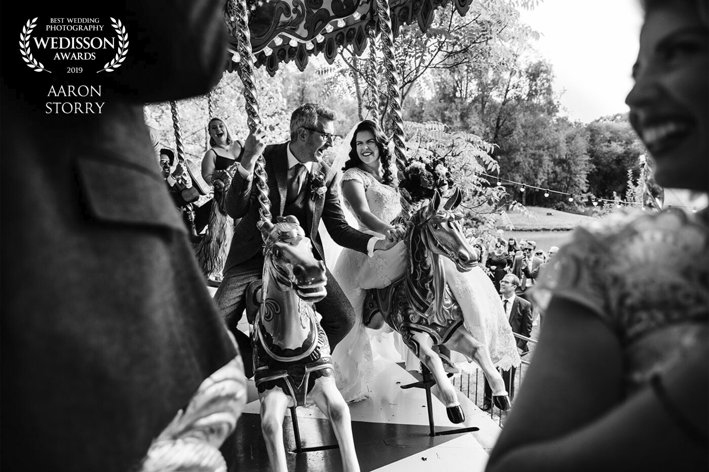When Charlotte & Neil promised all the fun of the fair they literally meant it!<br />
This gorgeous couple hired in the most incredible merry go round to entertain their guests on their wedding day - but before opening it up to the kids they took it for a test drive. This amazing picture was taken as the ride was spinning at full speed! I love the quirkiness and uniqueness of their wedding - it was a please and joy to document.